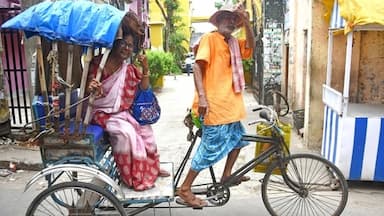 A rickshaw puller and his passenger show their ink-marked fingers in Hooghly, West Bengal.