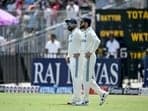 India's Virat Kohli (R) and captain Rohit Sharma arrive to field during the second day of the first Test cricket match between India and Bangladesh at the M.A. Chidambaram Stadium in Chennai on September 20, 2024