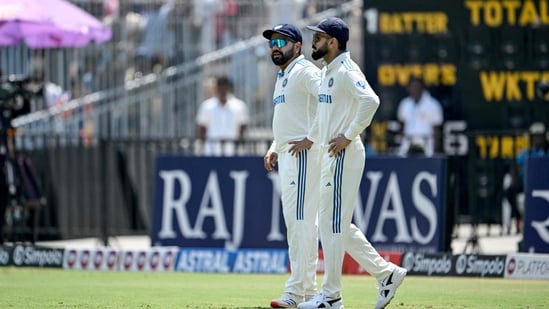 India's Virat Kohli (R) and captain Rohit Sharma arrive to field during the second day of the first Test cricket match between India and Bangladesh at the M.A. Chidambaram Stadium in Chennai on September 20, 2024